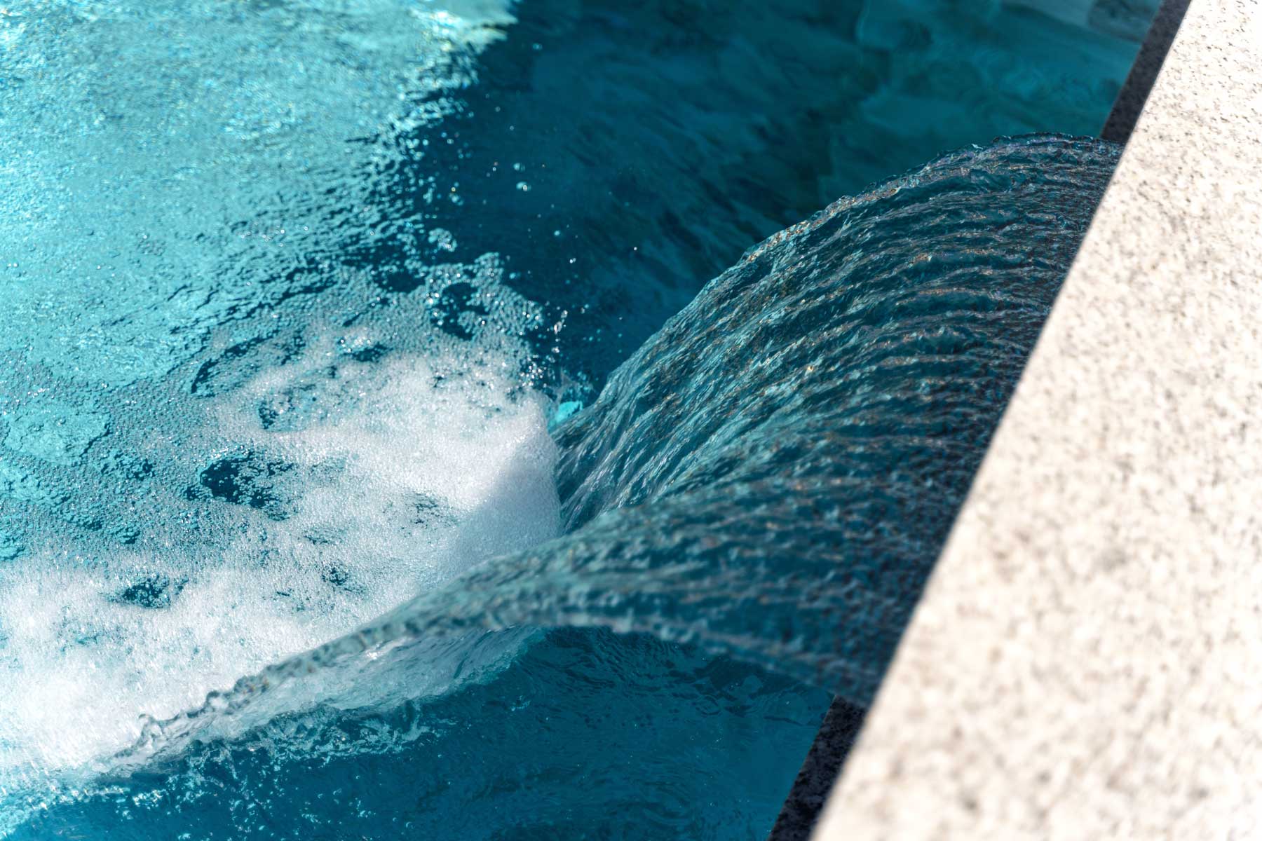 Pool water feature and lighting controlled through a smart home automation app in Chandler, AZ
