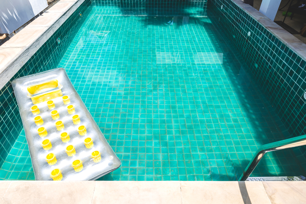 Water test kit beside a swimming pool
